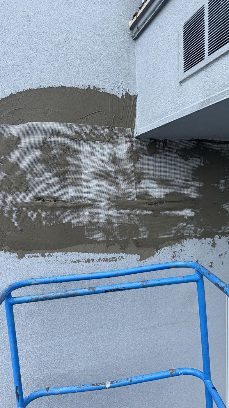 EIFS recoating in progress, half-finished wall